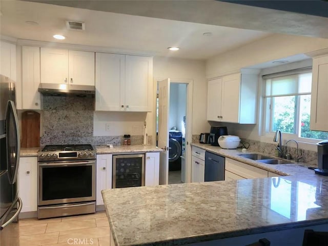 kitchen with white cabinetry, sink, stainless steel appliances, and beverage cooler