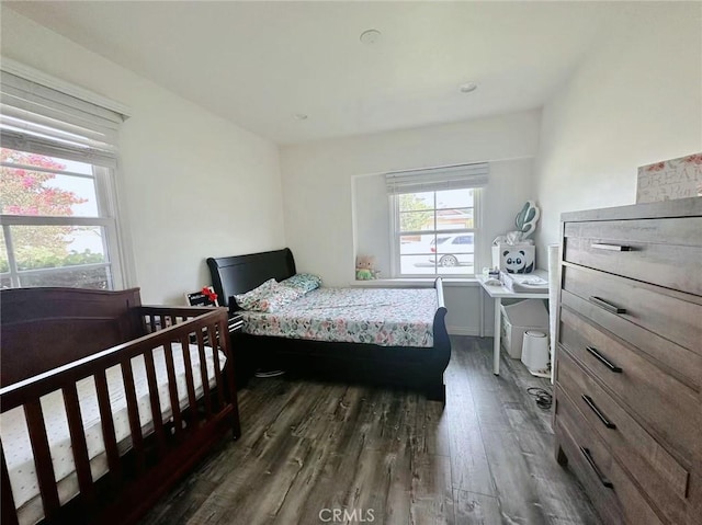 bedroom with dark wood-type flooring