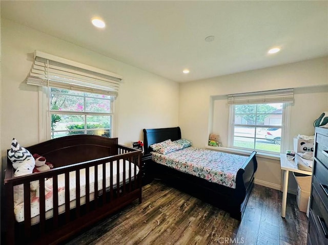 bedroom with dark hardwood / wood-style floors