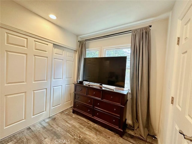 bedroom with a closet and light hardwood / wood-style flooring