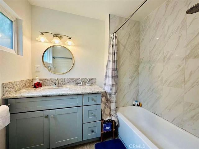 bathroom with shower / tub combo and vanity