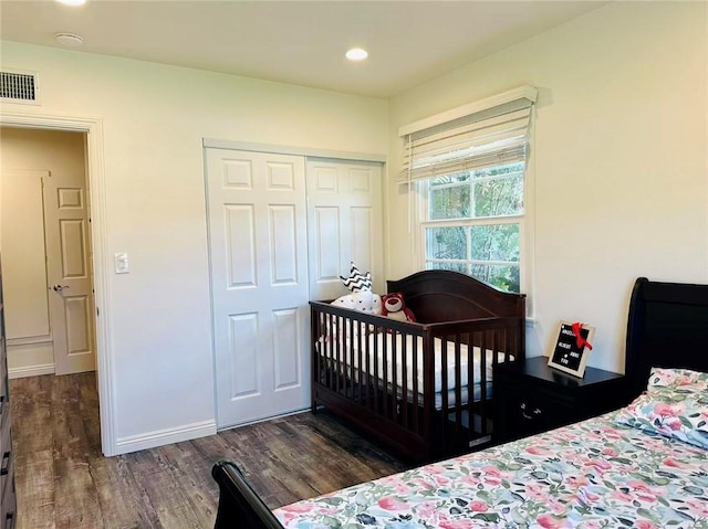 bedroom featuring dark hardwood / wood-style floors and a closet