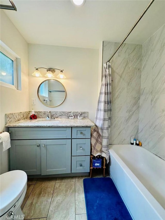 full bathroom with shower / bathtub combination with curtain, vanity, and toilet