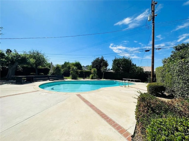 view of swimming pool with a patio area