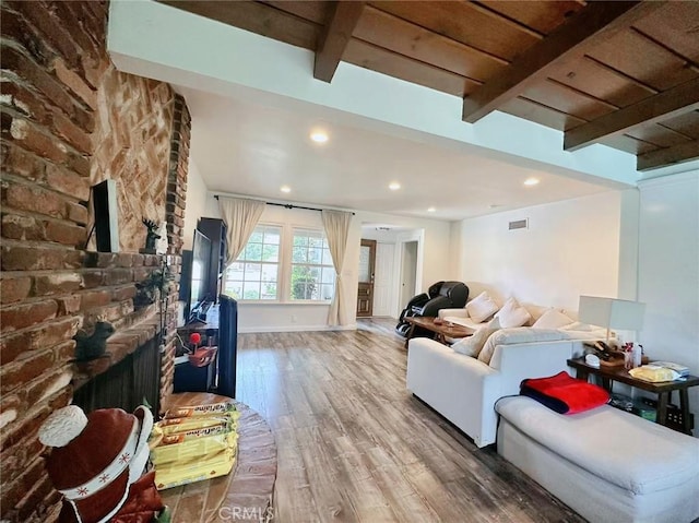 living room featuring wood-type flooring and beamed ceiling