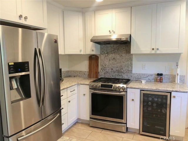 kitchen featuring white cabinetry, stainless steel appliances, beverage cooler, and light stone countertops