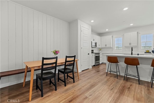 dining space featuring recessed lighting and light wood finished floors