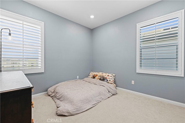 carpeted bedroom featuring baseboards and recessed lighting