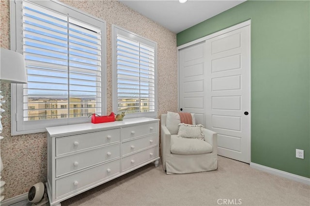 sitting room with light colored carpet, baseboards, and wallpapered walls