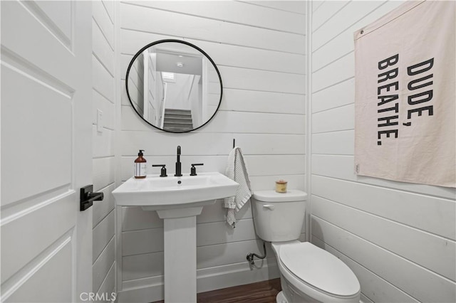 bathroom with toilet and wood finished floors