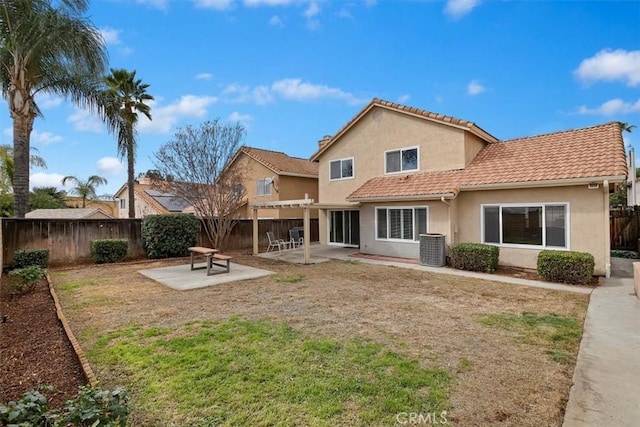 back of house featuring central AC unit, a pergola, a patio area, and a lawn