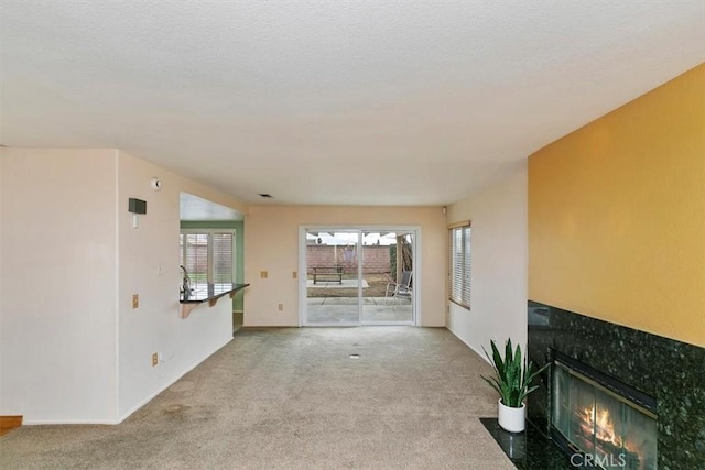 unfurnished living room featuring light carpet