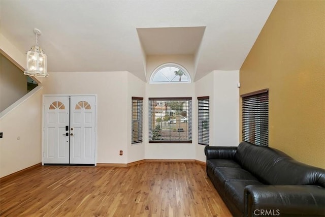 foyer entrance featuring hardwood / wood-style flooring and an inviting chandelier