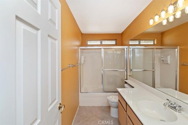 full bathroom with toilet, vanity, shower / bath combination with glass door, and tile patterned flooring