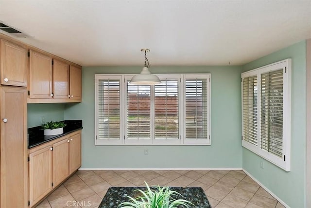 kitchen featuring pendant lighting, light brown cabinets, and light tile patterned floors