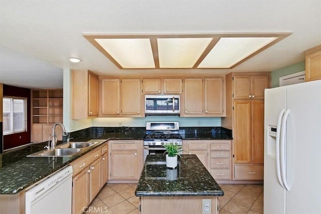 kitchen featuring light brown cabinetry, sink, dark stone counters, light tile patterned floors, and stainless steel appliances