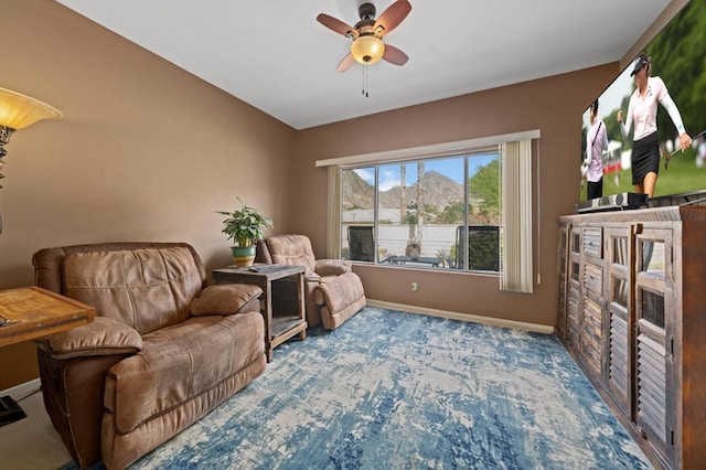 sitting room featuring ceiling fan and carpet