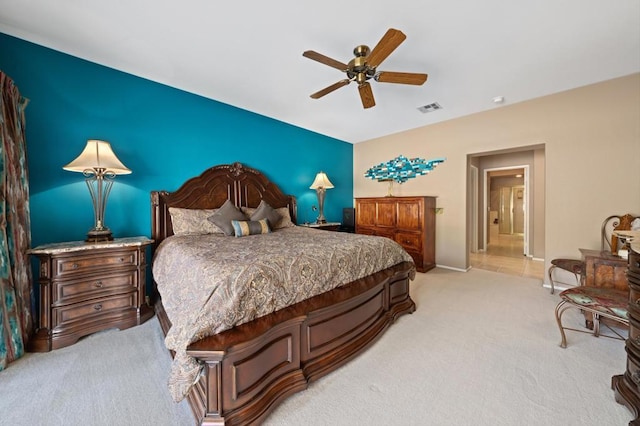 bedroom with ceiling fan and light colored carpet