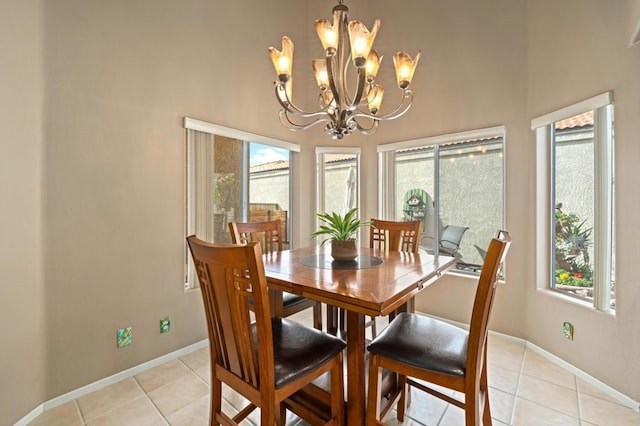 dining area with a chandelier and light tile patterned floors