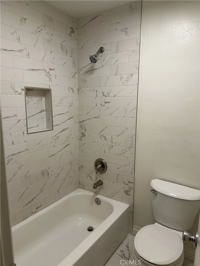 bathroom with toilet and tiled shower / bath combo