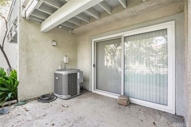 property entrance featuring central AC and a patio area