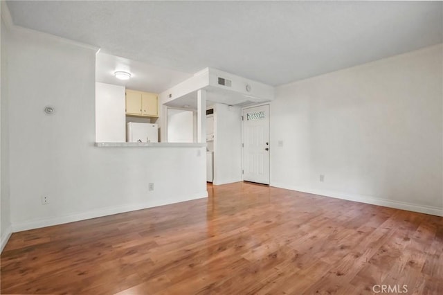 unfurnished living room featuring hardwood / wood-style floors