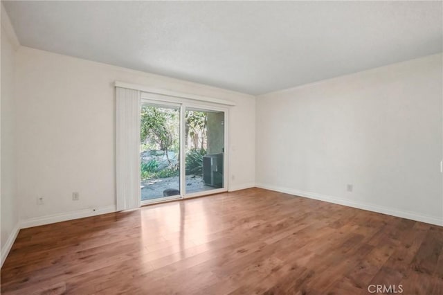 unfurnished room with wood-type flooring