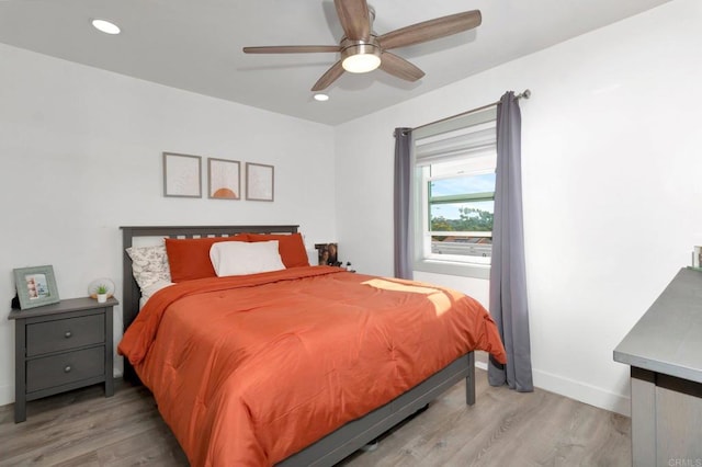 bedroom featuring ceiling fan and light hardwood / wood-style floors