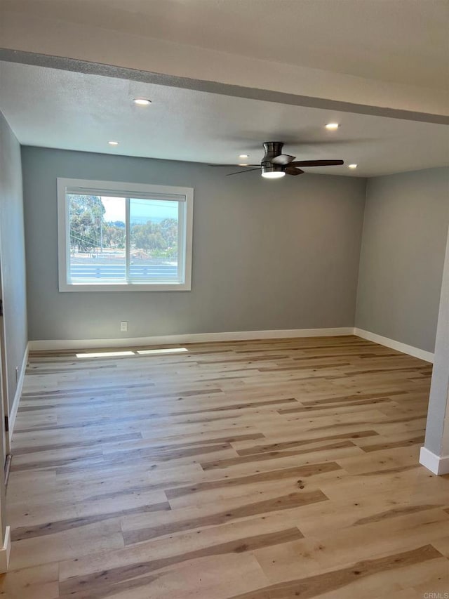 spare room featuring light hardwood / wood-style floors and ceiling fan