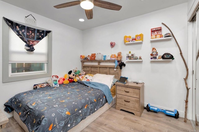 bedroom with a closet, ceiling fan, and light wood-type flooring