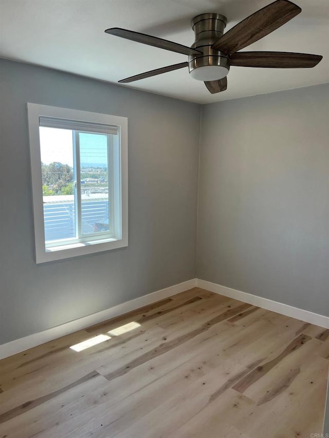 spare room featuring ceiling fan and light wood-type flooring