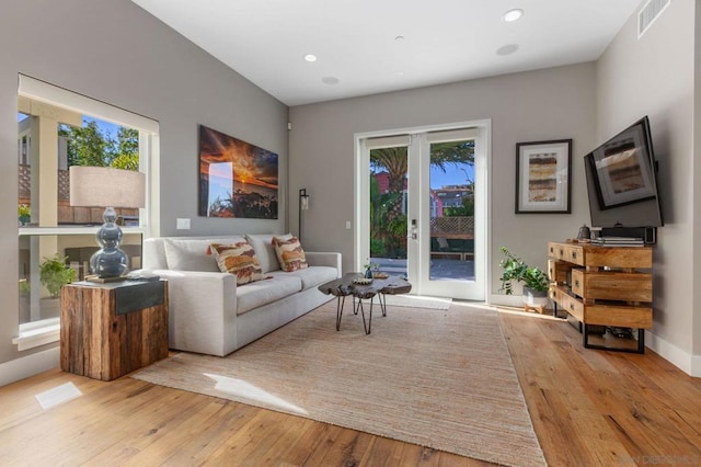 living room with plenty of natural light and light hardwood / wood-style flooring