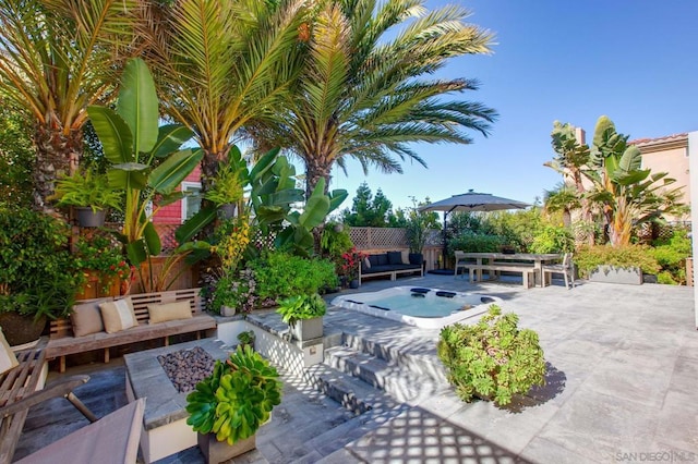 view of patio / terrace featuring a jacuzzi and an outdoor hangout area