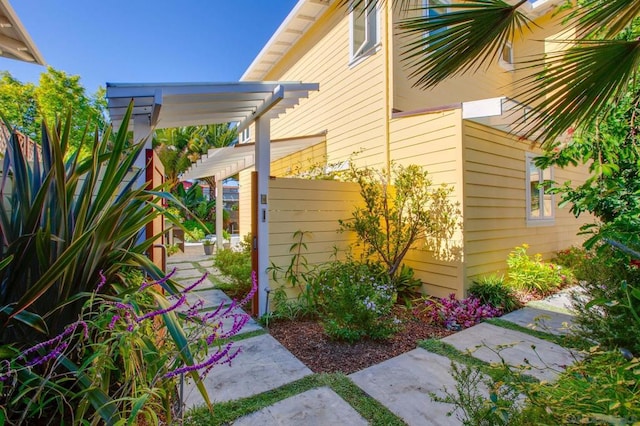 view of property exterior with a pergola