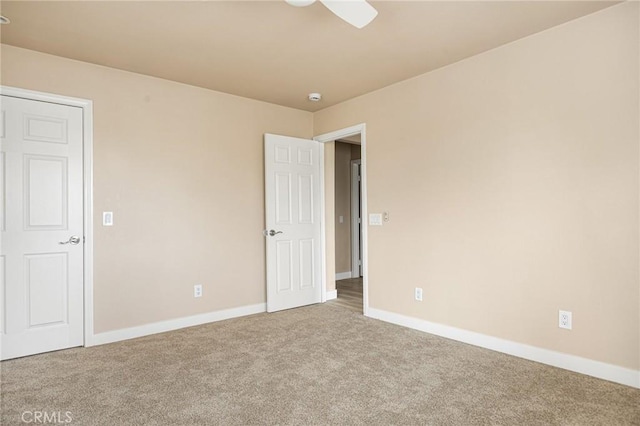 spare room with carpet flooring and ceiling fan