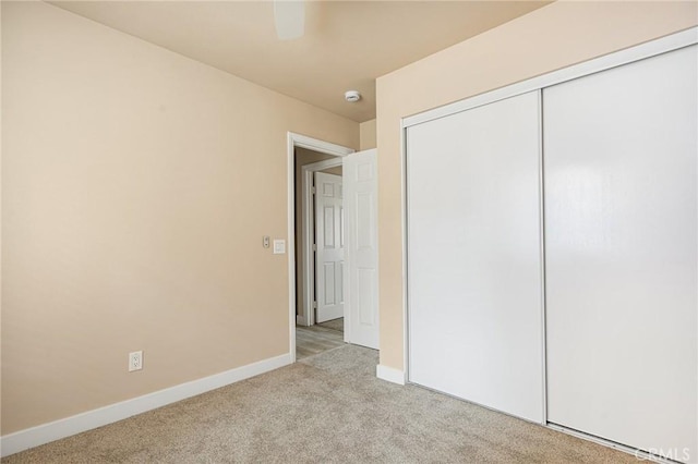 284 Davos Dr, Crestline, CA 92325 - unfurnished bedroom featuring light carpet, baseboards, a closet, and a ceiling fan