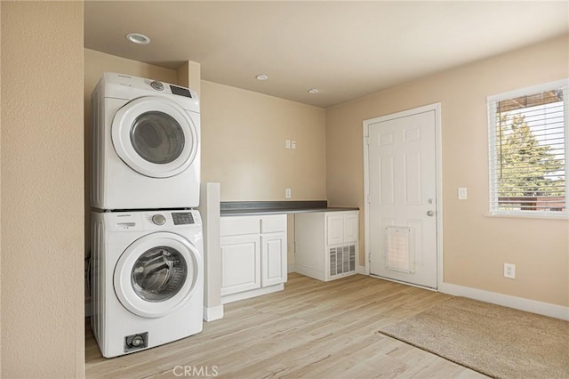 284 Davos Dr, Crestline, CA 92325 - washroom featuring stacked washer / dryer, light wood-type flooring, and baseboards