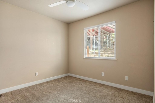 unfurnished room featuring light carpet and ceiling fan