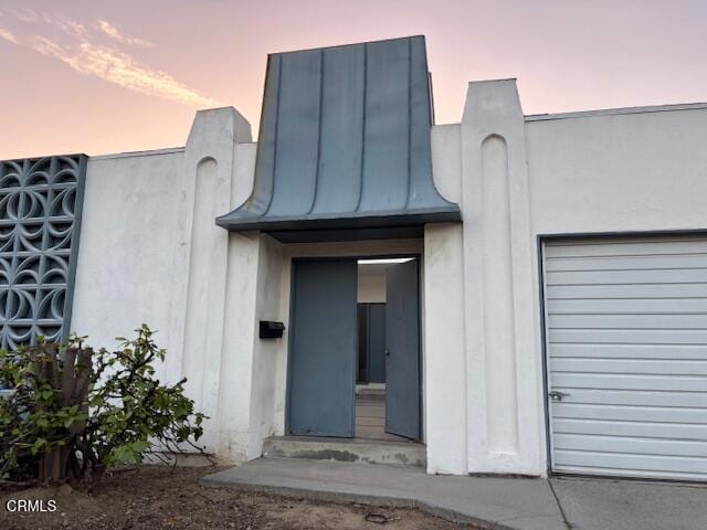 view of exterior entry at dusk