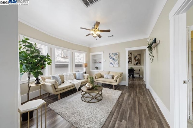 living room with ornamental molding, dark hardwood / wood-style floors, ceiling fan, and built in shelves