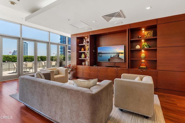 living room featuring dark hardwood / wood-style flooring, built in shelves, floor to ceiling windows, and french doors