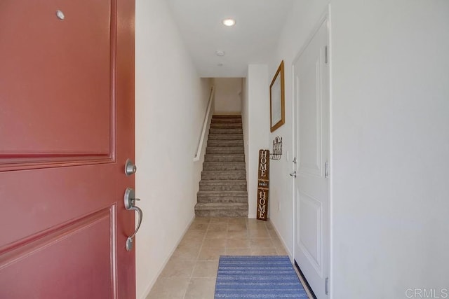 doorway to outside with light tile patterned floors