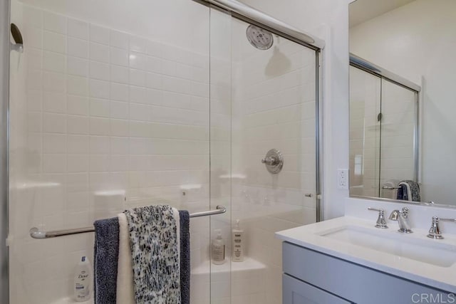 bathroom featuring vanity and an enclosed shower