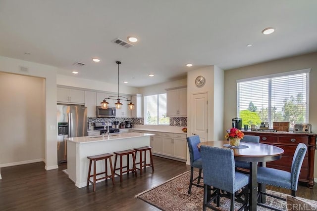 dining area with sink and dark wood-type flooring