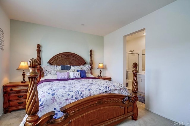 bedroom featuring ensuite bathroom and light colored carpet