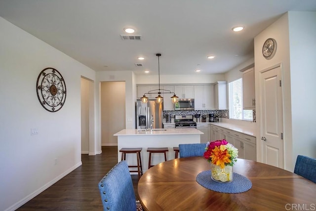 dining area featuring dark hardwood / wood-style floors and sink