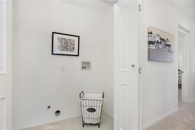 clothes washing area with washer hookup and light tile patterned floors