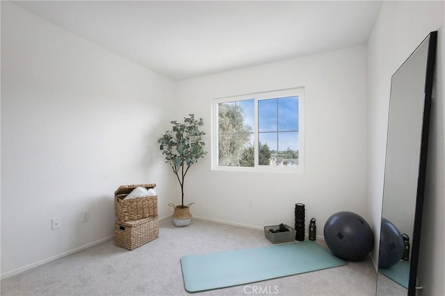 exercise room with light colored carpet