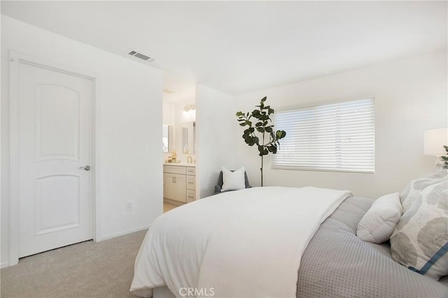 carpeted bedroom with connected bathroom