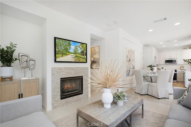 tiled living room with a tile fireplace